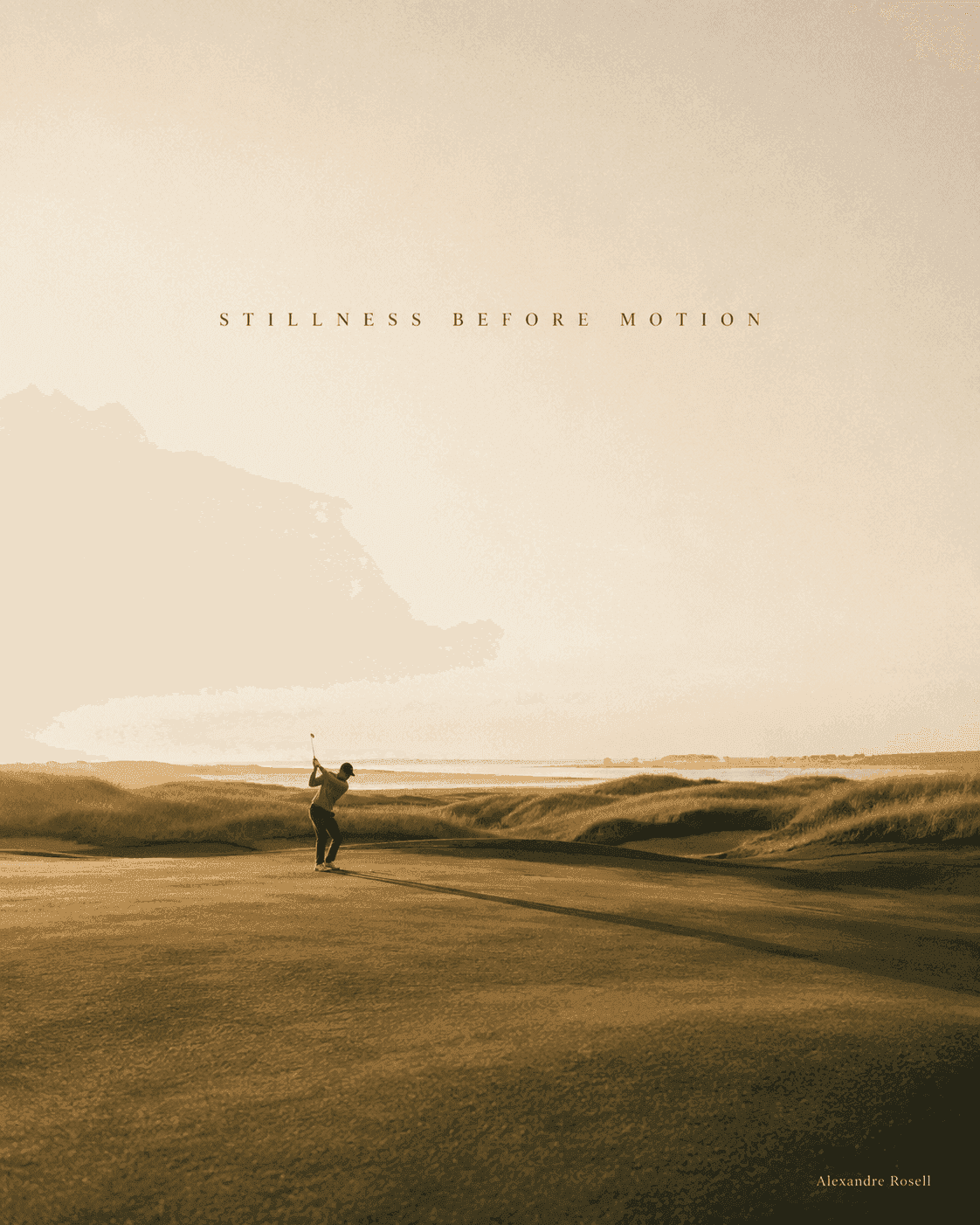 A golfer at the top of the backswing on a links fairway at golden hour, the sea beyond.